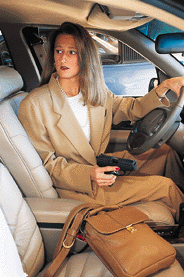 Woman in car, in parking garage.